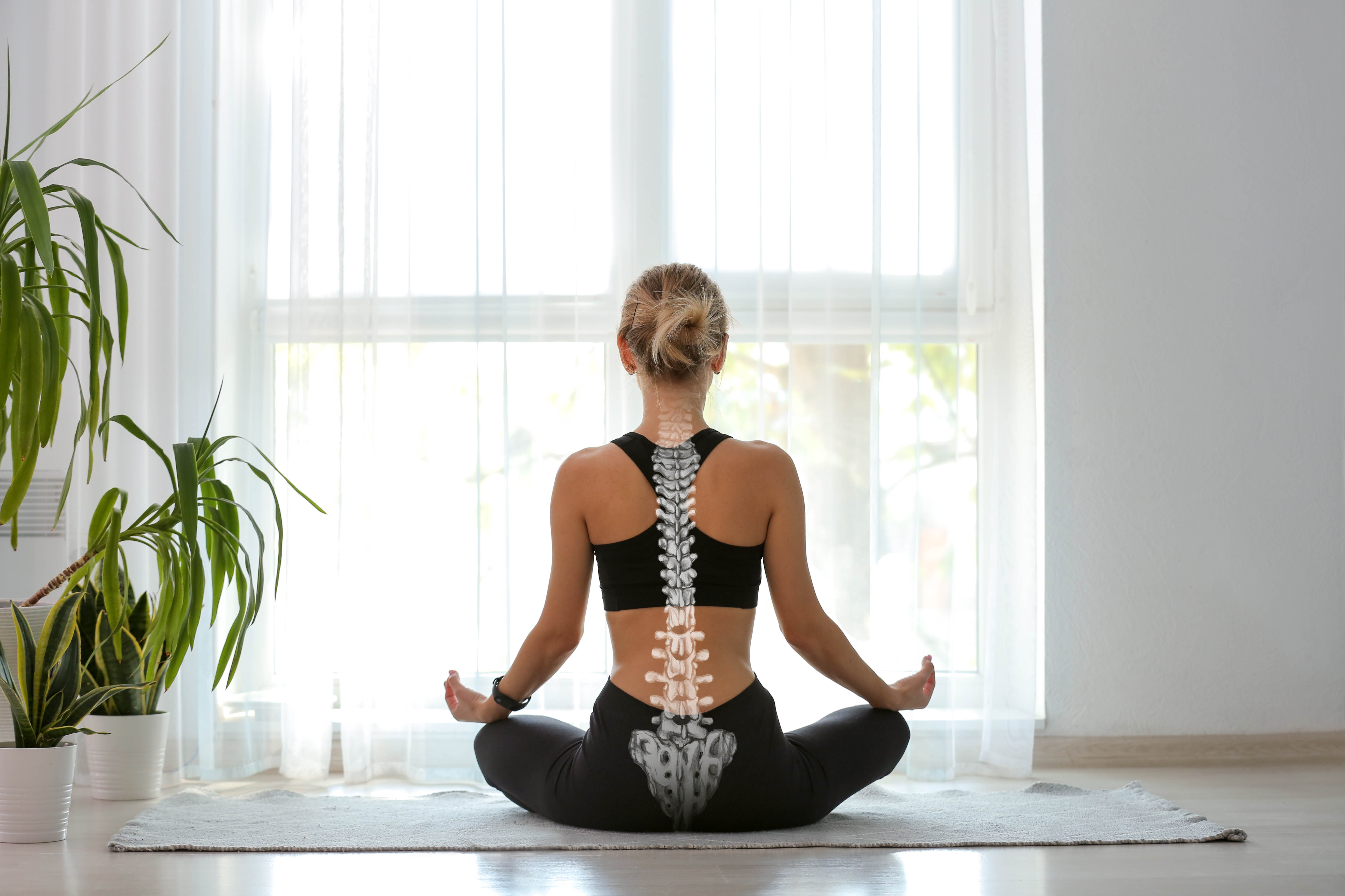 Shot of female in a mediation and yoga position with an x-ray of her straight spine, demonstrating good posture